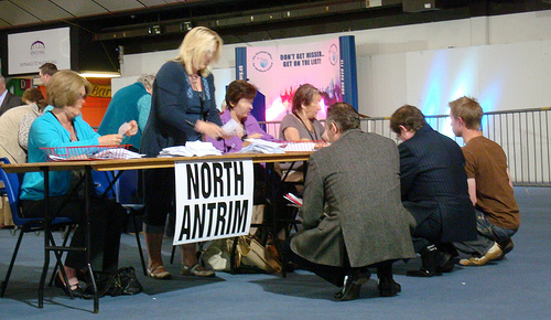 Ian Paisley Junior and others hunkered down on the ground tallying votes being validated face down at the 2009 European Election