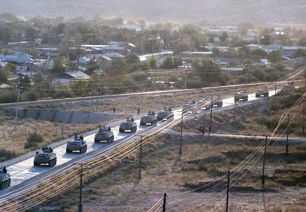 Soviet APCs depart Afghanistan as part of the first phase of troop withdrawal in 1986.