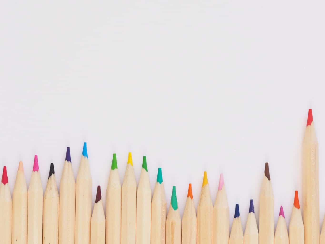colored pencil lined up on top of white surface