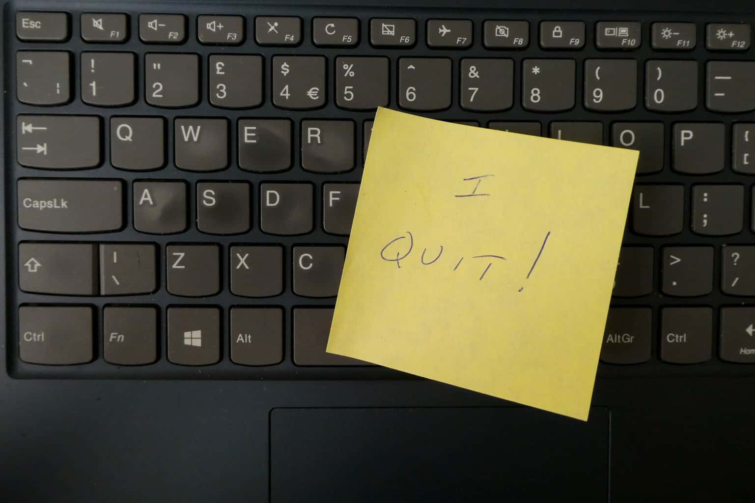 I quit written on a post it note, stuck to a keyboard.